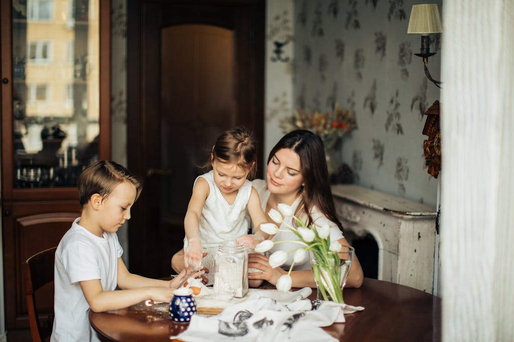 Mother and children baking together in a cozy home setting.